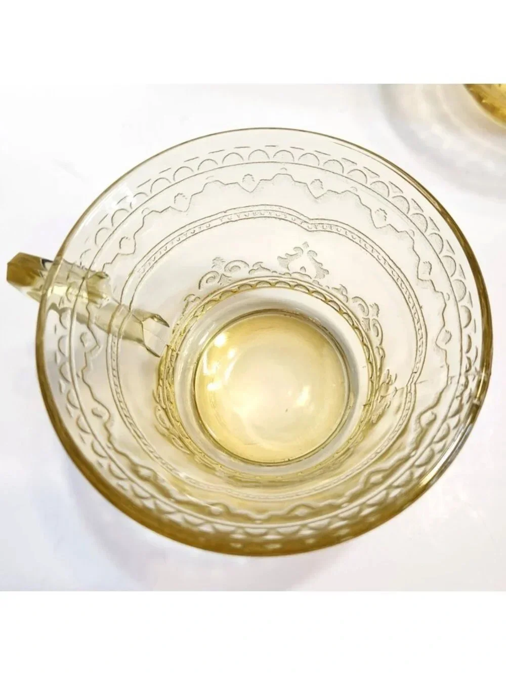 Elegant Amber Glass Teacup with Etched Decorative Pattern